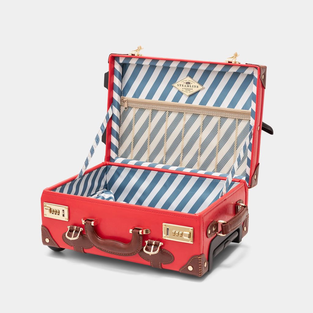 Red suitcase with open lid showing blue and white striped interior on a light gray background