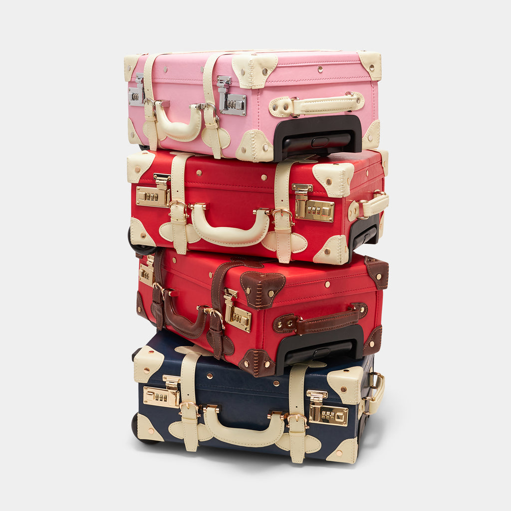 Stack of colorful suitcases on a white background