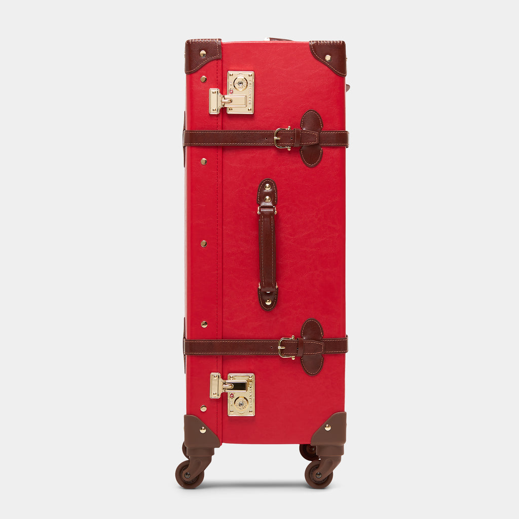 Red suitcase with brown accents on a white background