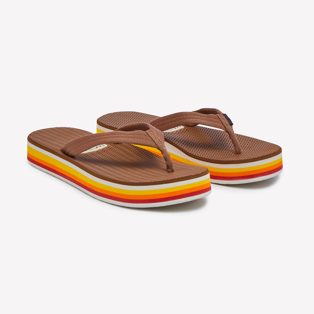 Brown flip-flops with colorful stripes on a white background