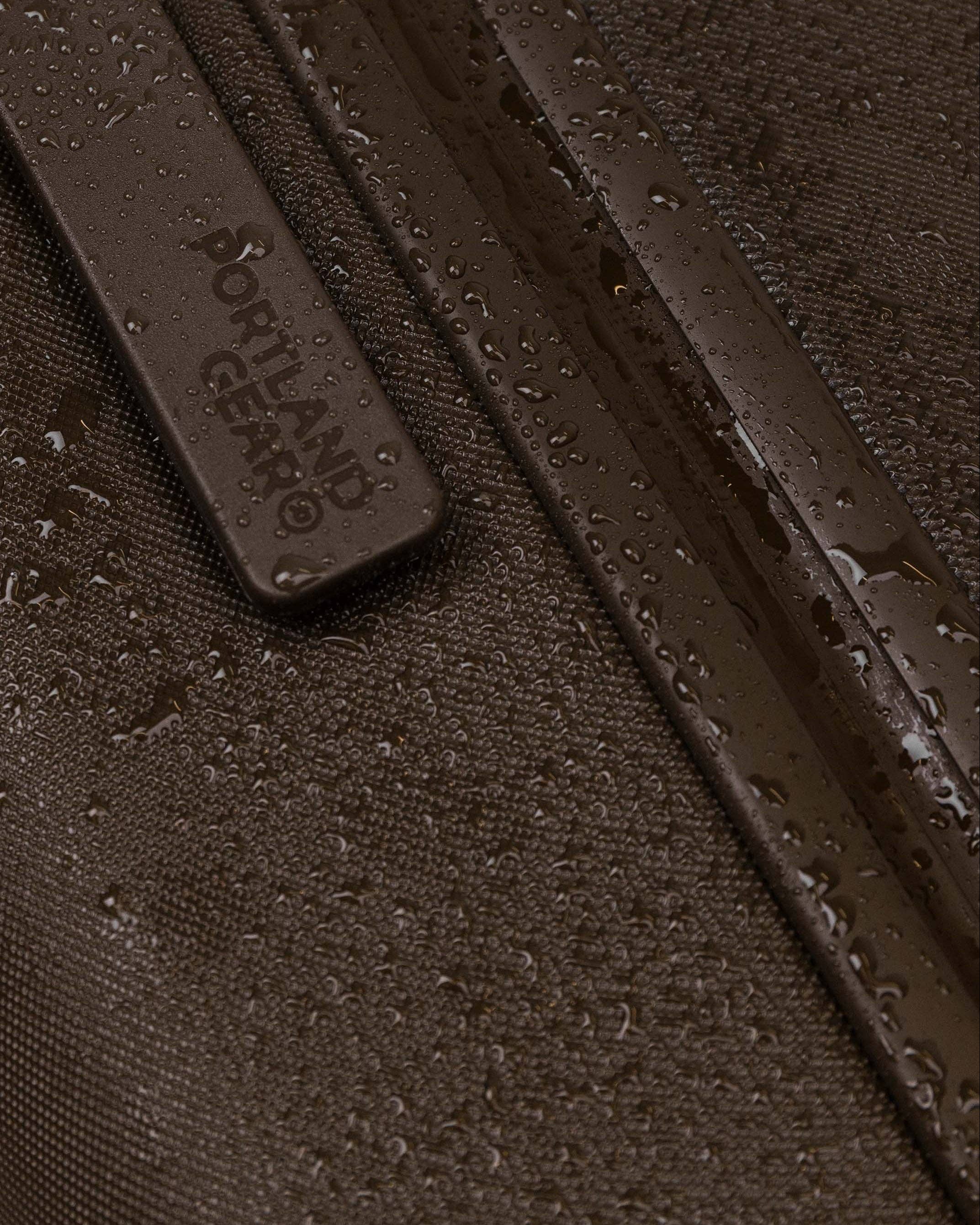 Close-up of a textured brown surface with 'Portland Gear' branding.